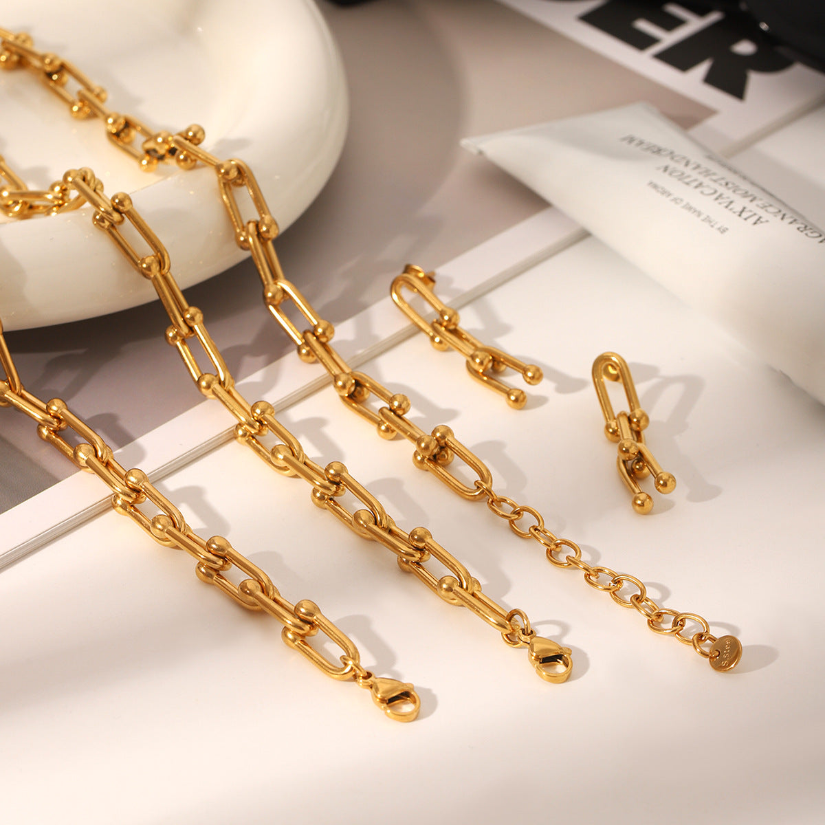 Set including necklace, horseshoe chain bracelet and earrings is made of high quality stainless steel