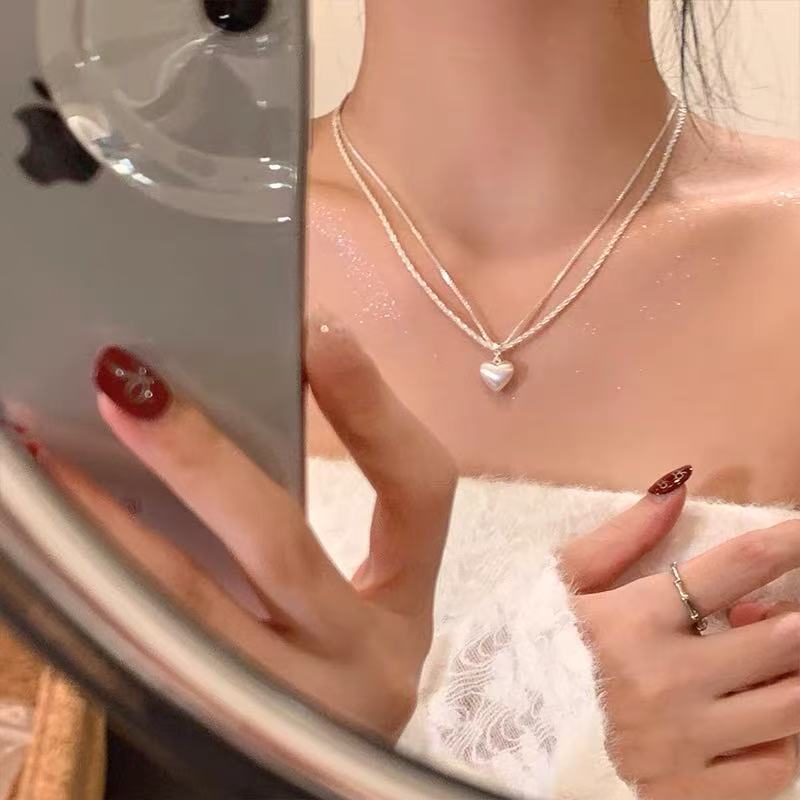 Women's brushed double-layer heart pendant necklace combines elegance and modernity. Crafted from thick, silver-plated white copper.