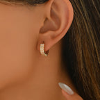 Women's earrings feature a modern geometric design, characterized by round shapes, dots and rings that harmoniously intertwine