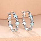 Earrings combine brilliance and delicacy, enhancing