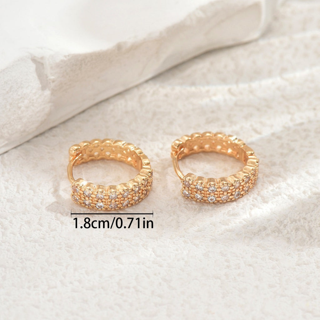 Women's earrings feature a modern geometric design, characterized by round shapes, dots and rings that harmoniously intertwine