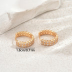 Women's earrings feature a modern geometric design, characterized by round shapes, dots and rings that harmoniously intertwine