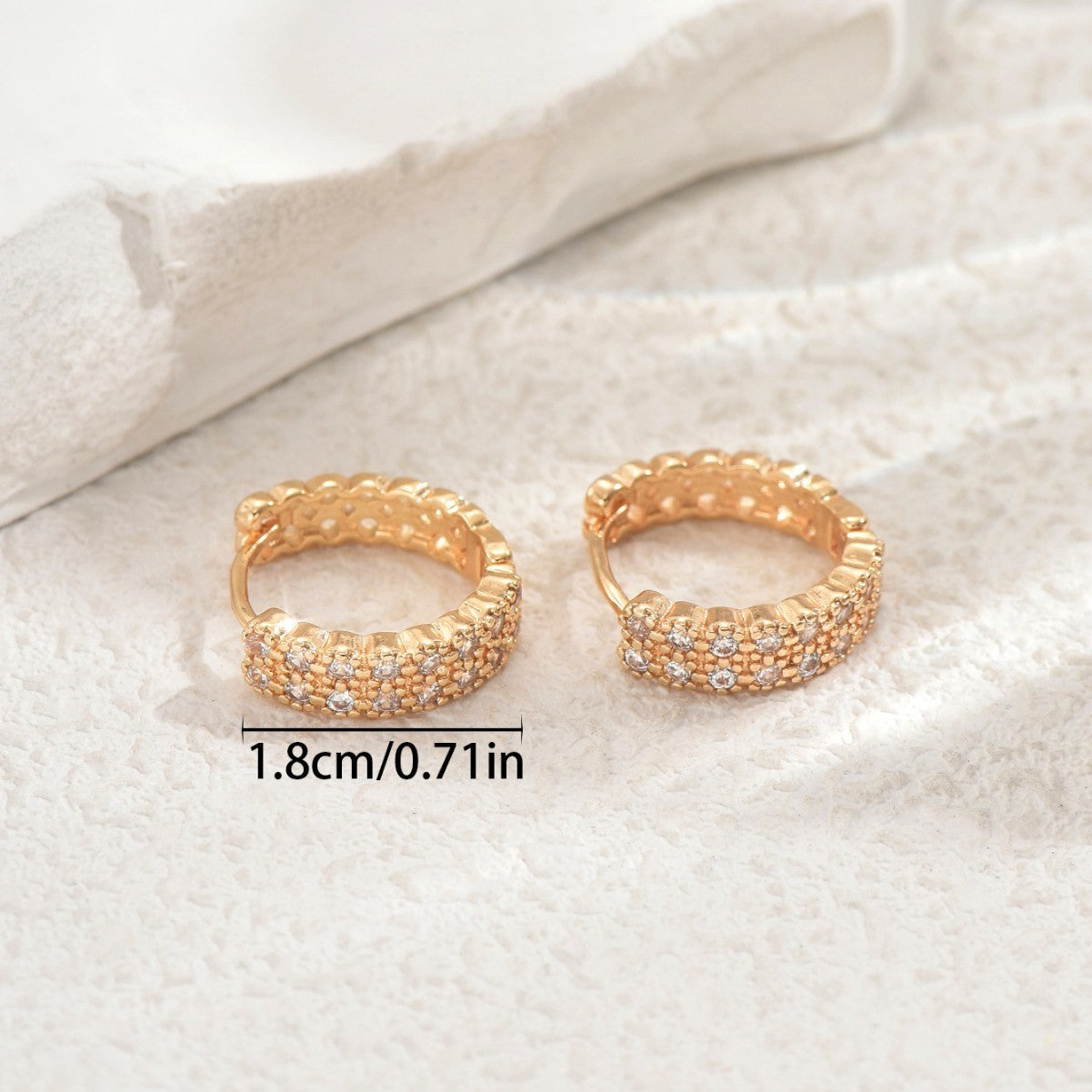 Women's earrings feature a modern geometric design, characterized by round shapes, dots and rings that harmoniously intertwine