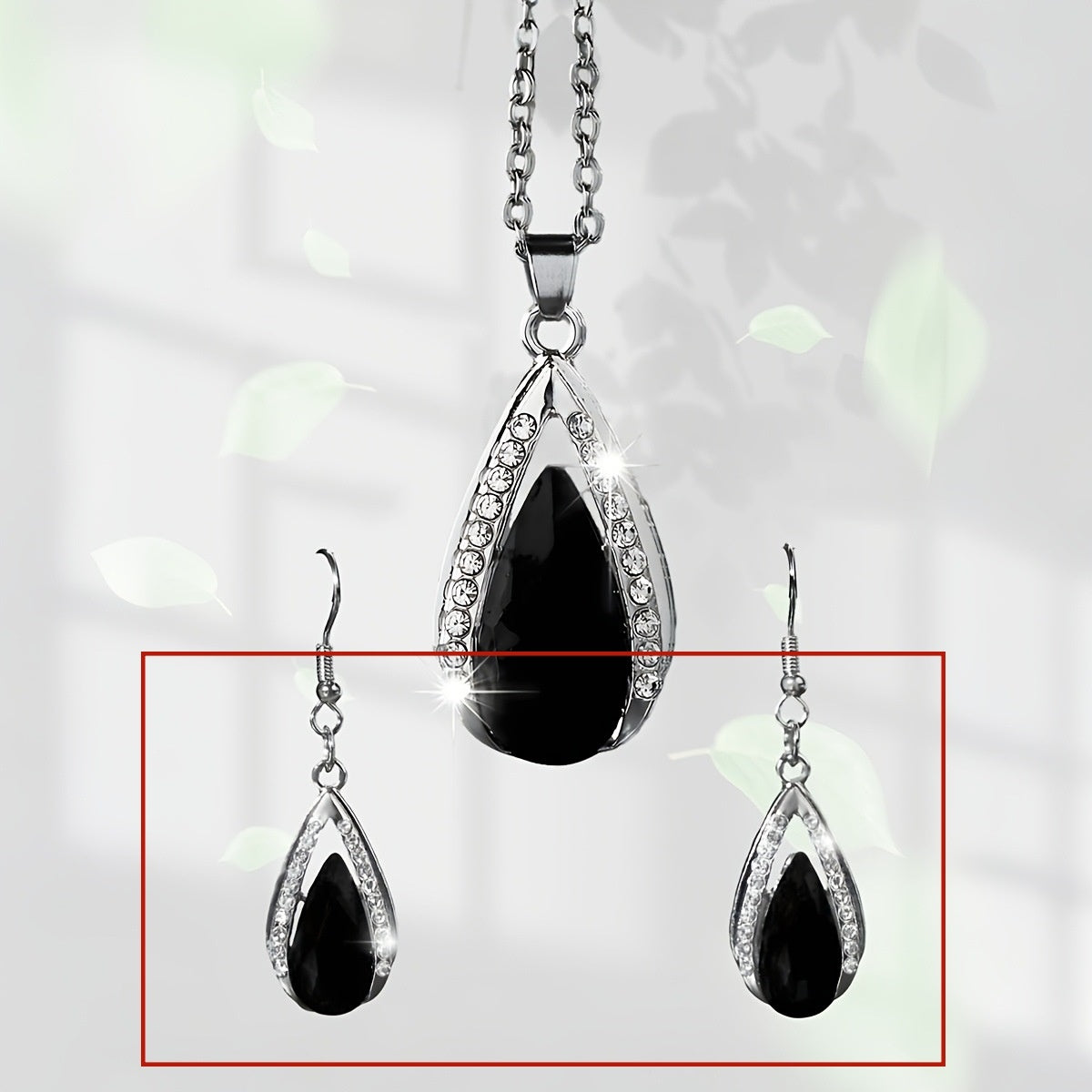 This set of a necklace and a pair of earrings features an elegant design with glass drop pendants.