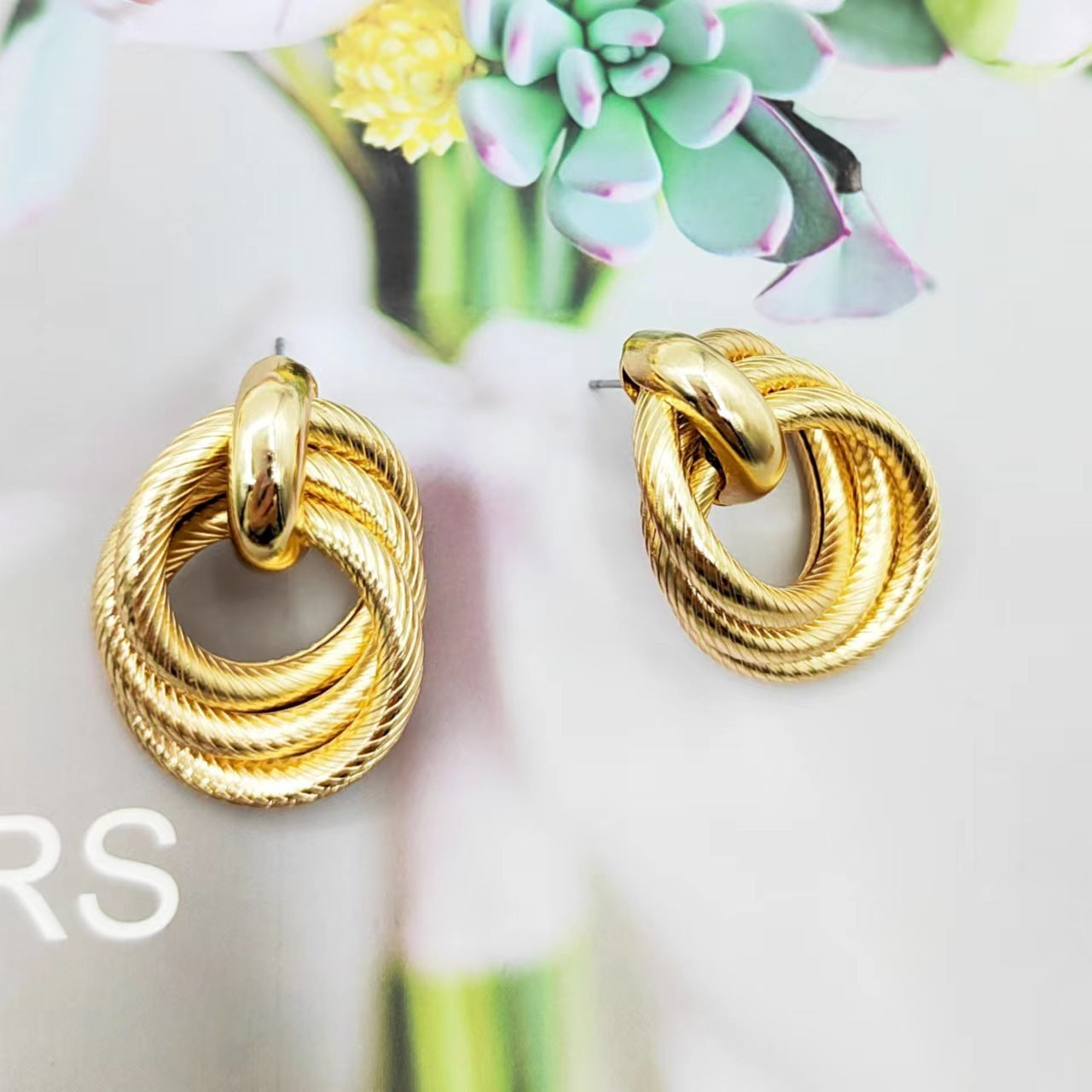 Geometric stud earrings with embossed and twisted ring