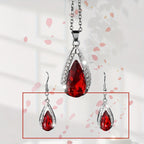 This set of a necklace and a pair of earrings features an elegant design with glass drop pendants.