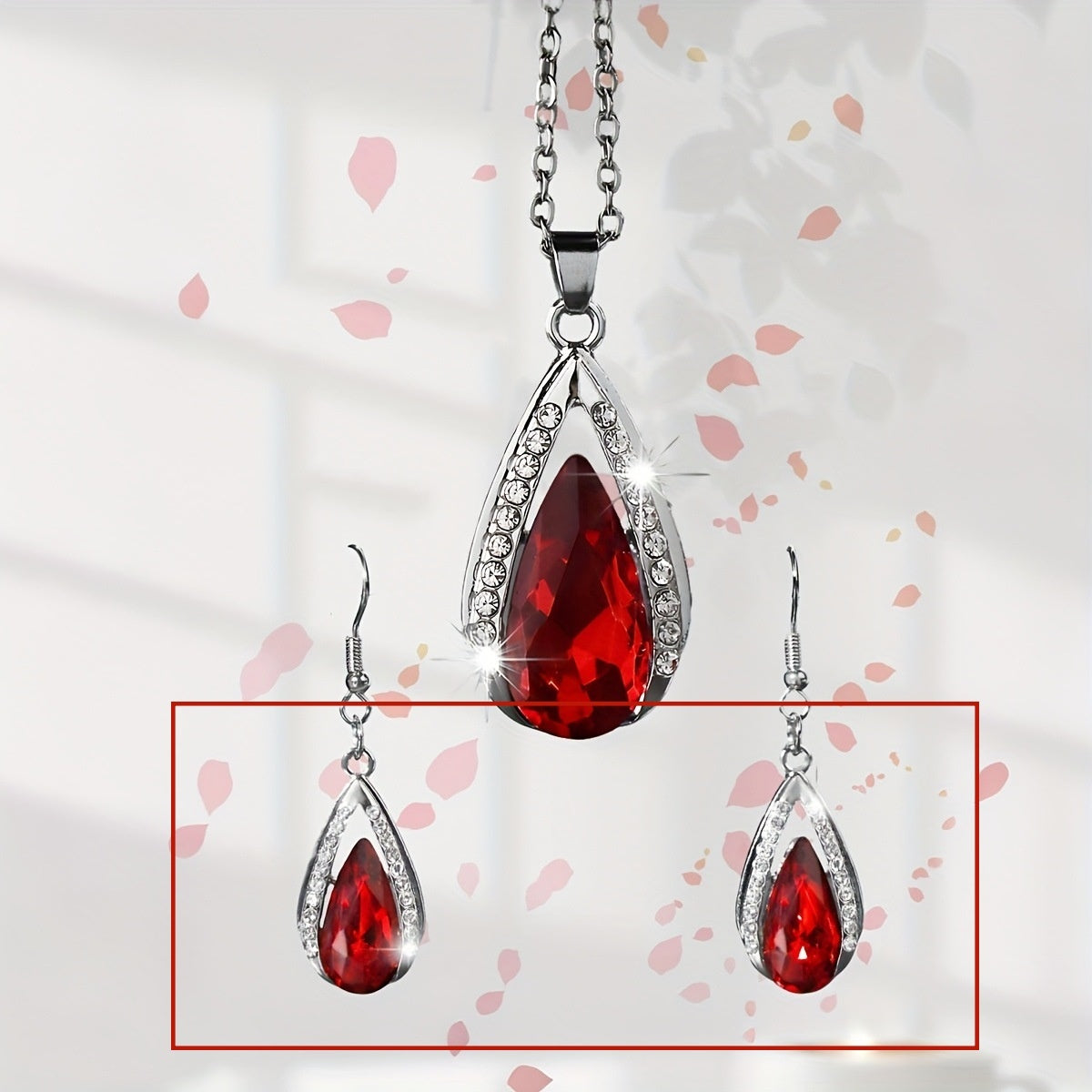 This set of a necklace and a pair of earrings features an elegant design with glass drop pendants.