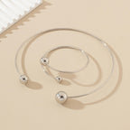 Open bangle bracelet, decorated with balls of various sizes, combines contemporary design and minimalist elegance.