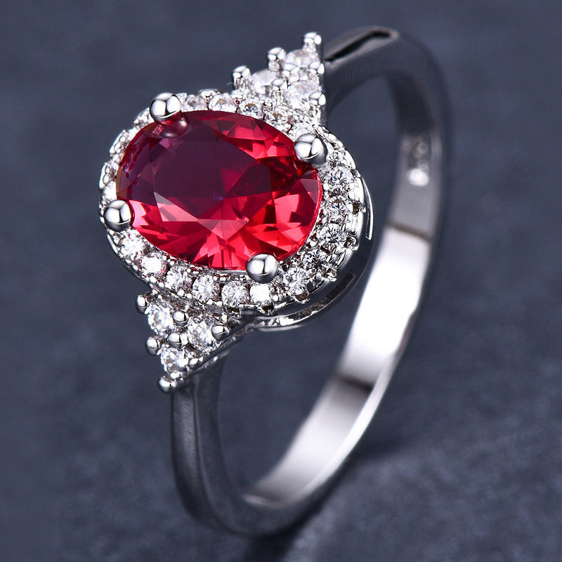 This women's ring is distinguished by its elegant oval shape, highlighting a sublime ruby ​​set in a white gold-plated copper metal.