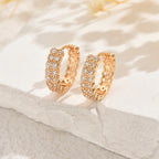 Women's earrings feature a modern geometric design, characterized by round shapes, dots and rings that harmoniously intertwine