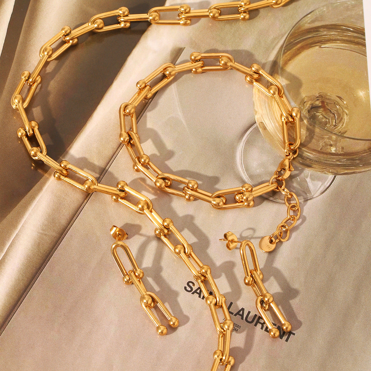 Set including necklace, horseshoe chain bracelet and earrings is made of high quality stainless steel