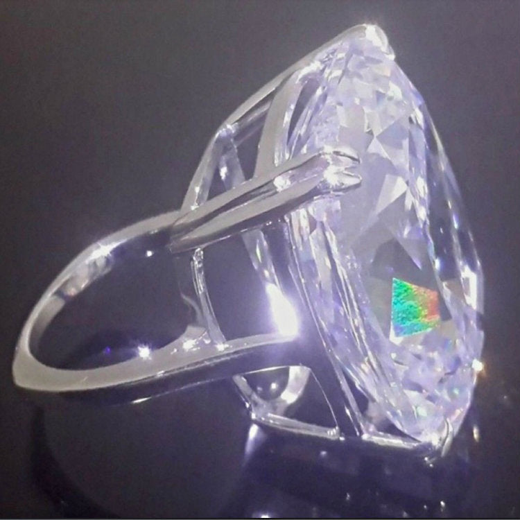 Simple ring in white gold plated alloy, delicately set with a white square diamond