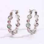 Earrings combine brilliance and delicacy, enhancing