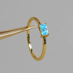 women's ring combines elegance and simplicity with its subtle geometric design highlighting an oval-shaped sapphire blue zircon