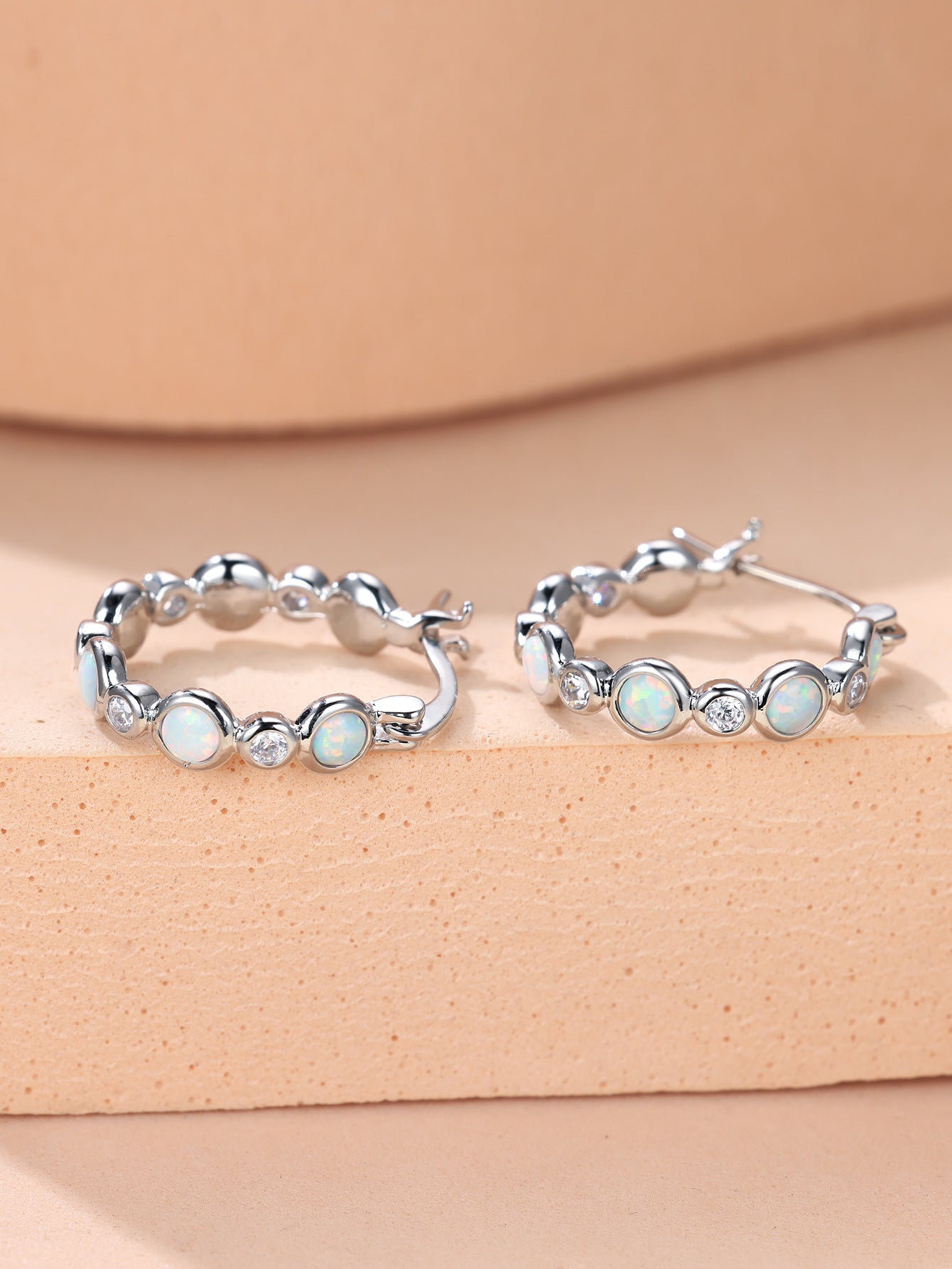 Earrings combine brilliance and delicacy, enhancing