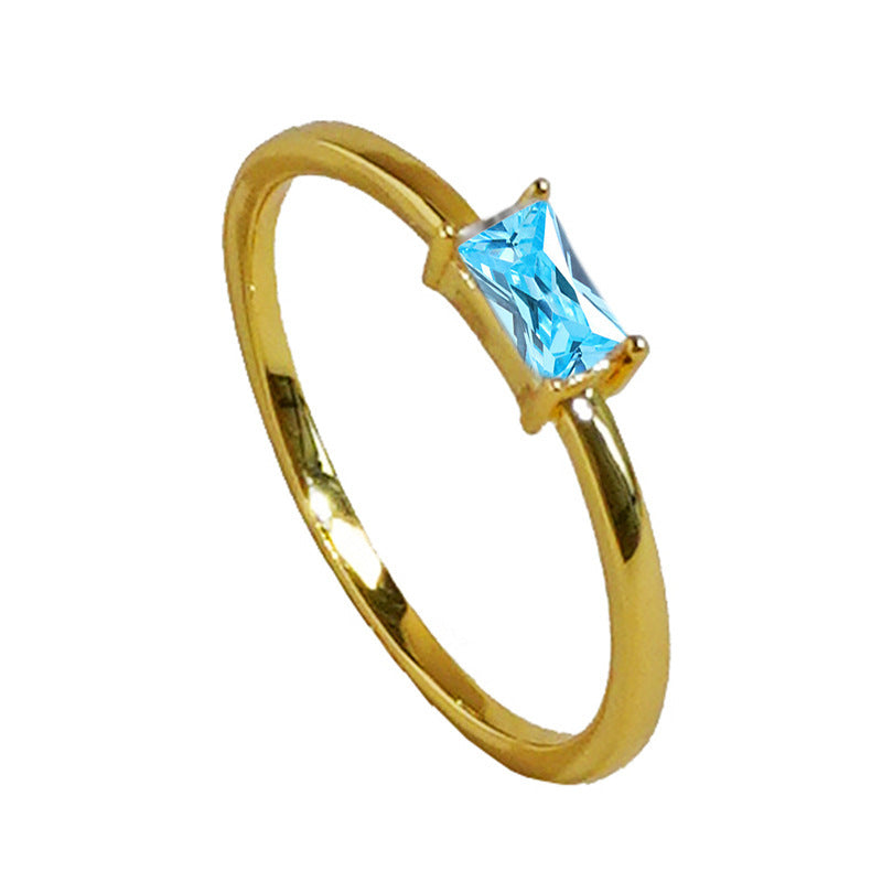 women's ring combines elegance and simplicity with its subtle geometric design highlighting an oval-shaped sapphire blue zircon