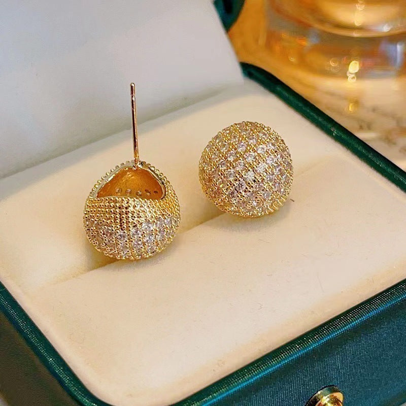 Light luxury clip-on earrings in the shape of small golden pearls adorned with diamonds